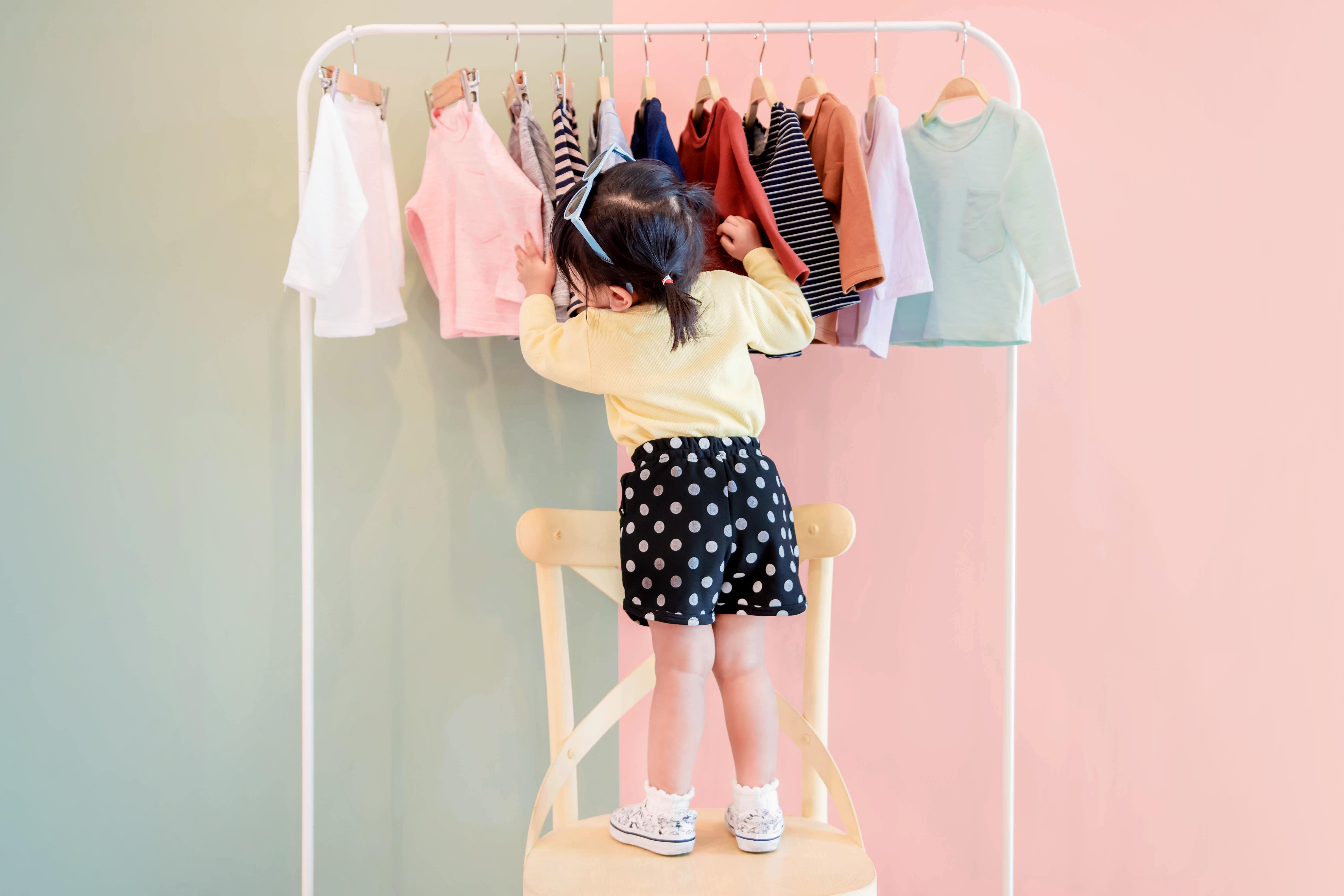 Little girl looking for the perfect dress